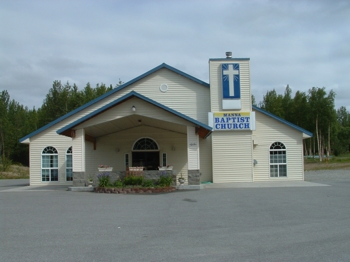 Front entrance of Manna Baptist Church with its steeple and cross