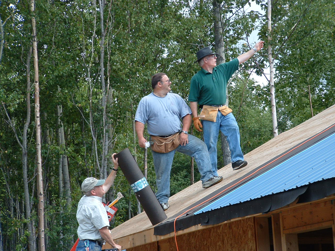Church volunteers working together on a roof